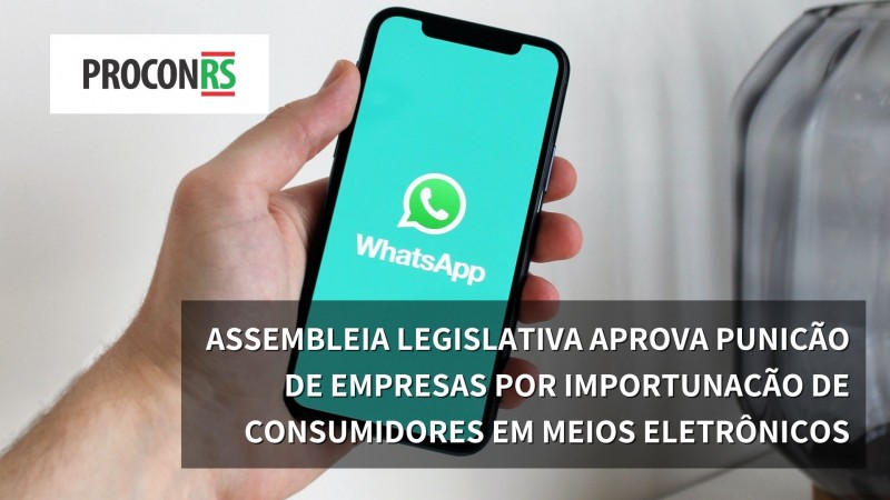 mão segurando telefone com o logotipo do whatsapp em destque